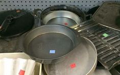 pots and pans are stacked on top of each other in a store display area