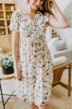 Our beautiful new Coral Floral Dress is a Blush Lane original design! This dress is light and airy, made with a Polyester material and fully lined. It has a tie at the waist, and a button down front on the bodice. Our Cora Dress has a v-neckline with puff sleeves and a midi length on the dress. We love the muted tones in the floral print and the flowy feel of this dress! Perfect throughout the year! This dress does fit true to size, but please refer to our sizing chart for more exact measurement Fashion Dresses For Women, Mother Clothing, Envy Clothing, Wedding Simple, Ladylike Style, Cute Comfy Outfits, House Dress, Costume Outfits, Tea Dress