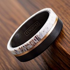 this is an image of a wedding ring made out of antelope wood and black ceramic