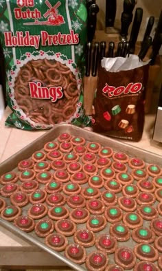 some cookies are on a cookie sheet with green and red frosting in the middle