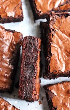 chocolate brownies with frosting on a white surface