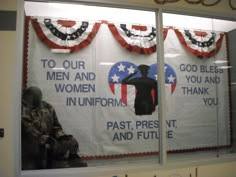 an american flag is reflected in the window of a woman's uniform storefront