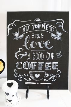 a chalkboard sign that says all you need is love and a good cup of coffee