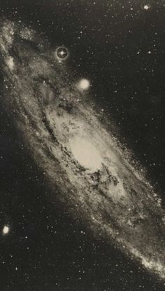 an old photo of the andromidus galaxy in black and white with stars