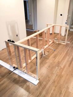 an unfinished room with hard wood flooring and white walls in the process of remodeling