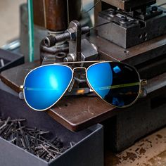 The Concorde, an iconic style named after the Concorde Supersonic passenger airliner, in a 23k Gold frame finish and our best-selling polarized Cobalt mirrored glass lenses. Style details include patterned bayonet temple tips embossed with our 1973 logo. Handcrafted in the USA. Classic Blue Aviator Sunglasses With Mirrored Lenses, Gold Mirrored Aviator Sunglasses For Travel, Gold Aviator Sunglasses With Polarized Lenses For Travel, Blue Mirrored Sunglasses For Travel, Blue Anti-reflective Aviator Sunglasses, Blue Aviator Sunglasses With Mirrored Lenses, Rose Gold Sunglasses, Blue Sunglasses, Pilot Sunglasses