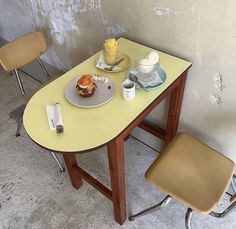 two chairs and a table with food on it