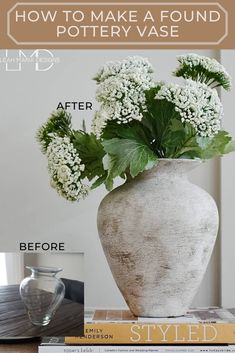 a vase filled with white flowers sitting on top of a table next to some books