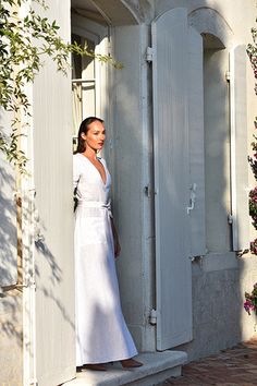 Escape to the South of France in our effortlessly chic, Cassis Linen Weekend Dress in crisp white. This highly tailored wrap dress is a timeless and sophisticated addition to your wardrobe and ready-to-wear. Materials: 100% Linen 210 gram OEKO-TEX® Certified Brand: Luxe Provence Lifestyle Color: White Two front pockets and adjustable side wrap linen belt Inseam Length (inner thigh to floor): 100 cm and can easily be hemmed as needed Available Sizes: X-Small (0-2), Small (USA 4-6), Medium (USA 8-10), Large (USA 12-14), XL (USA 16 -18) Adjustable belt allows this wrap dress to accommodate variations in body sizes. If you are unsure of your size, please contact us and we can verify the best fit, prior to ordering at: orders@luxe-provence.com. Care instructions: Hand wash cool at 30-40 degrees White Linen Dress Summer, White Wrap Dress, Weekend Dresses, Summer Linen Dresses, Slow Fashion Brands, The South Of France, Aging Gracefully, South Of France, Linen Clothes