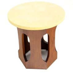 a small wooden table with two holes in it