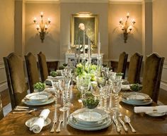 a formal dining room table set with place settings