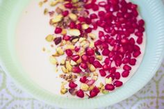 there are pomegranates and nuts on the plate