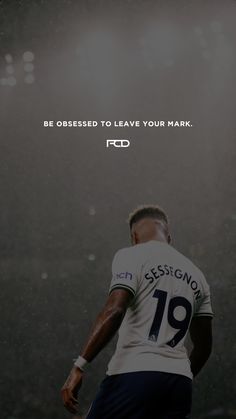 a man standing in front of a soccer field with the words be dressed to leave your mark