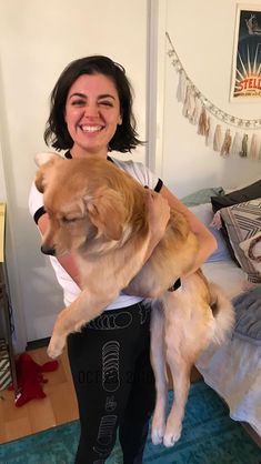 a woman holding two dogs in her arms