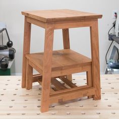 a small wooden stool sitting on top of a hard wood floor