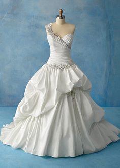 a white wedding dress on a mannequin headdress in front of a blue background