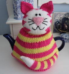 a knitted cat sitting on top of a table