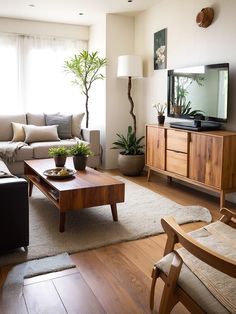 a living room filled with furniture and a flat screen tv on top of a wooden table