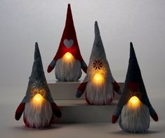 three gnomes with lights on their heads are sitting next to each other