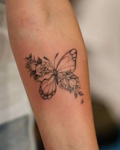 a woman's arm with a butterfly tattoo on it