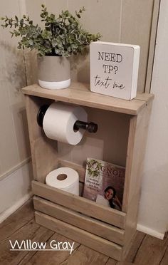 a toilet paper dispenser sitting on top of a wooden shelf