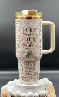 a coffee cup that has been decorated with words on it and beads around the mug