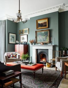 a living room filled with furniture and a fire place in front of a painting on the wall