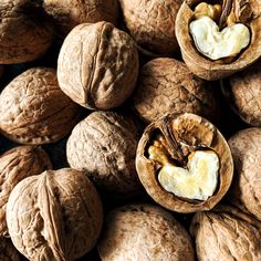 walnuts and an egg are shown in this close - up photo, with the shell still open