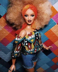 a barbie doll with blonde hair and blue eyes wearing a colorful top, denim shorts and heels