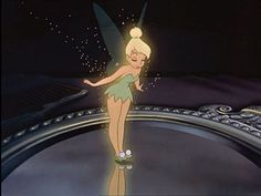 tinkerbell standing in front of a mirror