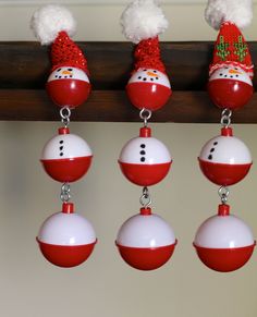 christmas ornaments are hanging from the ceiling in front of a wall with snowmen on them