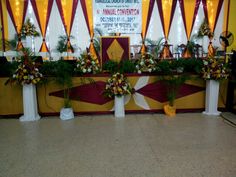 flowers are placed in vases on the side of a stage set up for a performance