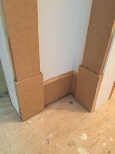 the corner of a room with cardboard on the floor