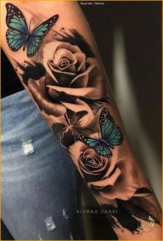 a woman's arm with roses and butterflies on it