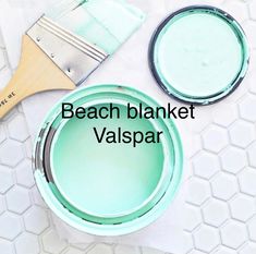 two paint pans and a brush with the words beach blanket valispar on them