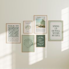 a white wall with several framed pictures on it and some words above the frames that say spring is coming