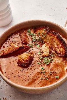 a bowl filled with soup on top of a table