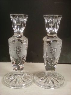 two clear glass vases sitting on top of a table