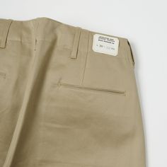 This brand new wide fitting chino from Buzz Rickson’s has been inspired by a 1942, US Army issue chino. The timeless vintage shape has been complimented by a high rise, and plenty of authentic detailing. Designed for comfort and ease of movement, the wide leg opening of this model makes this trouser very breathable and easy to wear. Known for their attention to detail, Buzz Rickson’s have custom manufactured a set of metal US Army sew in buttons for added authenticity. Two side entry pockets and Trousers Details Menswear, Buzz Rickson, Pant Details, Trousers Details, Formal Pants, Pants Details, French Army, Cotton Chinos, Sew In