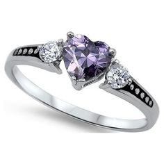 a heart shaped ring with three stones on the side and two diamonds at the top