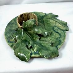 a green leaf shaped dish on a white table