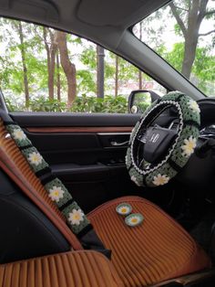 the interior of a car with steering wheel cover and flowers on it's center console