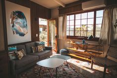 a living room filled with furniture and lots of windows