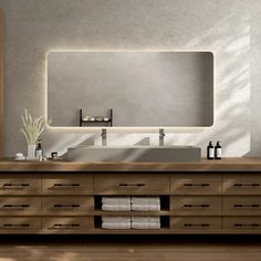 a bathroom vanity with two sinks and a large mirror