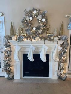 a fireplace decorated for christmas with stockings and snowflakes