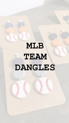 three pairs of baseball themed earrings with the words milb team dangles on them