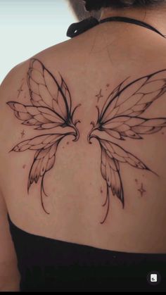 the back of a woman's shoulder with a butterfly tattoo on it