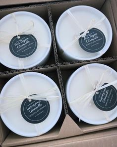 four white plates in a box tied with twine