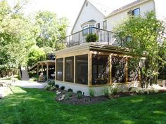 a house with a covered patio in the front yard