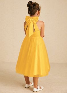 Dora features a charming A-line silhouette in matte satin and tulle, with a stylish halter neckline and playful bows. Sleeveless and easy to wear with a zipper back, it’s perfect for adding a touch of elegance to any special occasion. Yellow Flower Girl Dress, Yellow Flower Girl Dresses, Tea Length Flower Girl Dress, Tea Length Tulle, Military Ball Dresses, Sage Dress, Special Event Dresses, Lace Bride, Marigold Flower